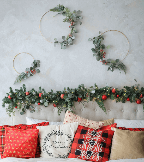 A wreath hung above the bed with red, white pillows