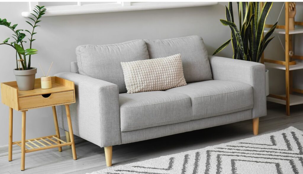A wooden side table with a drawer underneath