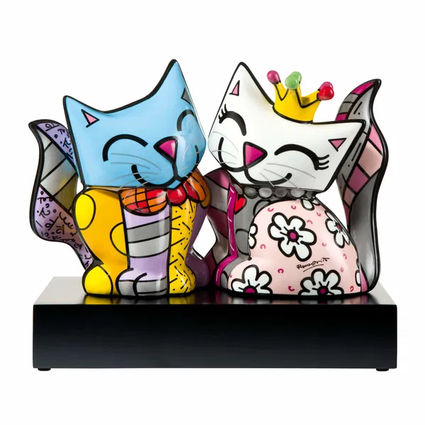 Adorable porcelain couple of cats, one with a crown and the other with a bow tie, decorated in playful, bold colors.