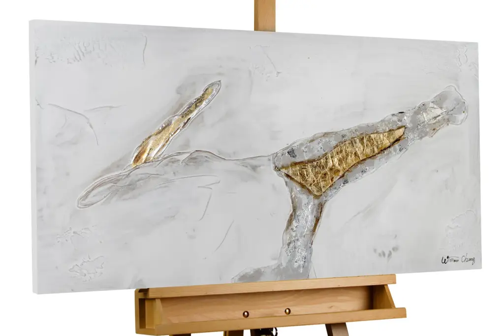 An abstract mixed-media painting on an easel, featuring white and grey textures with distinct gold leaf accents.