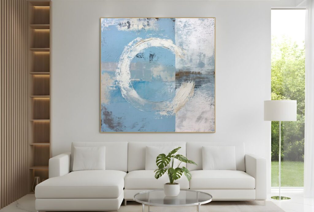 Abstract blue and white circular painting above sofa