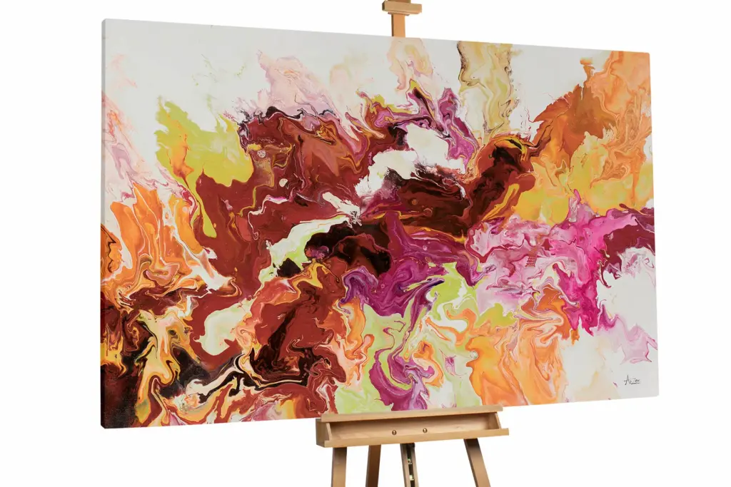 An expansive abstract painting on an easel with warm tones of gold, orange, and magenta blending into soft white and cream.